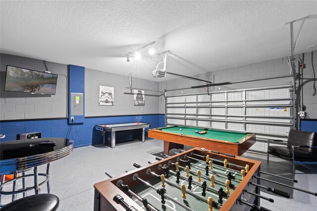 game room featuring electric panel, a textured ceiling, and billiards