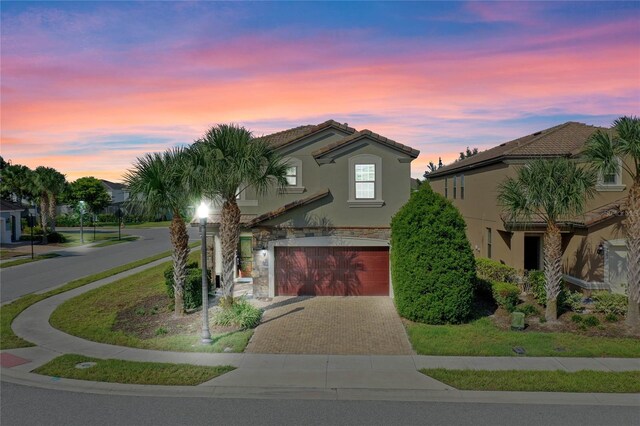 mediterranean / spanish-style home featuring a garage