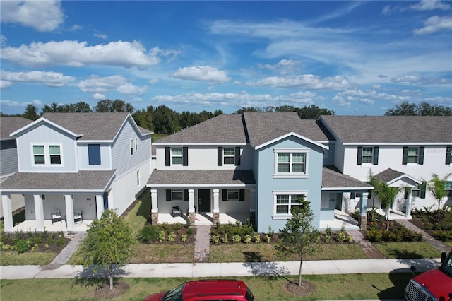 view of front of property with a front yard, covered porch, and a patio area