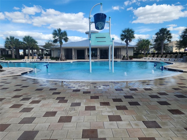 view of pool with pool water feature and a patio area