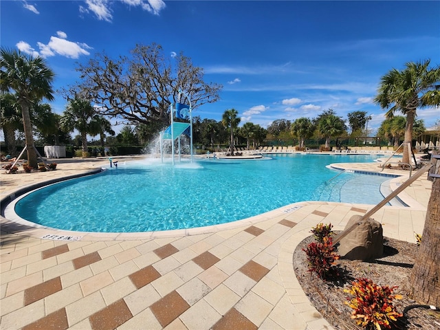 view of pool with pool water feature and a patio area