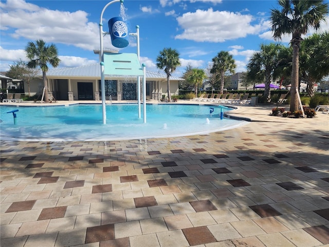 view of pool with a patio area and pool water feature