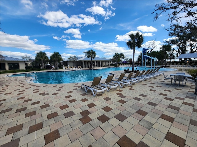 view of swimming pool with a patio