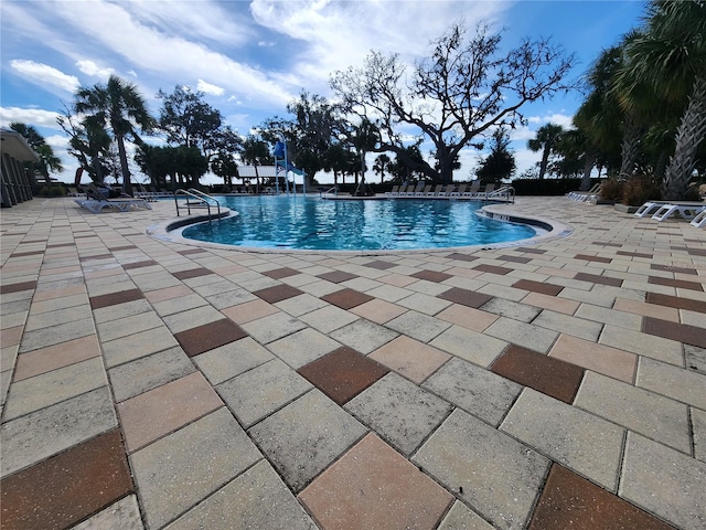 view of swimming pool with a patio