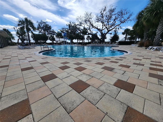 view of swimming pool featuring a patio area