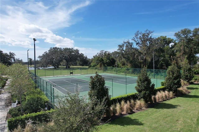 view of sport court featuring a lawn