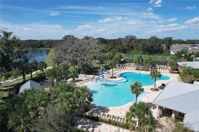 view of swimming pool with a patio and a water view