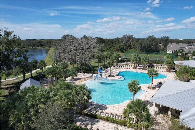 view of pool with a patio and a water view