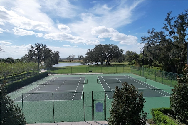 view of sport court with a water view