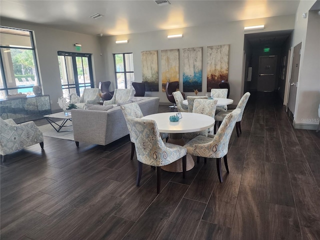 dining space featuring french doors and dark hardwood / wood-style flooring