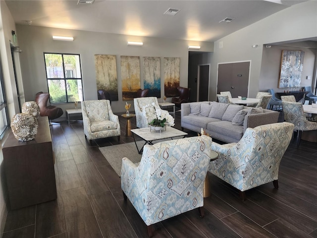 living room with lofted ceiling and dark hardwood / wood-style flooring