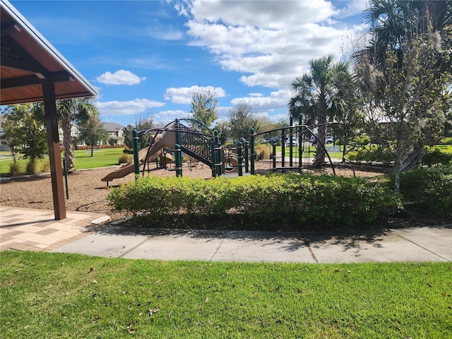 view of jungle gym featuring a lawn