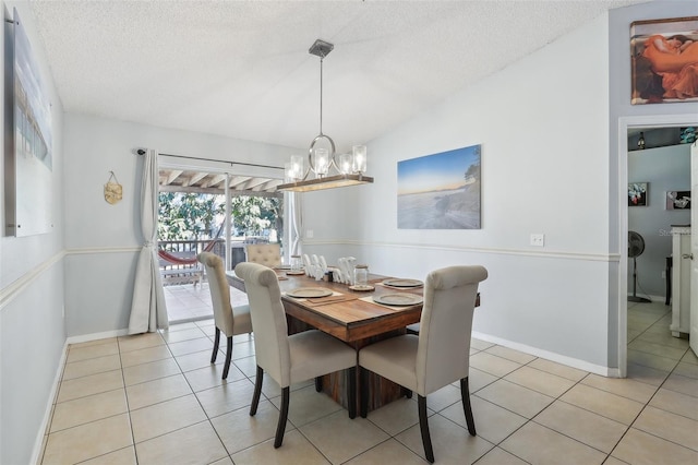 tiled dining space with vaulted ceiling, a textured ceiling, and an inviting chandelier