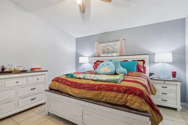 bedroom featuring light tile patterned floors, a textured ceiling, and ceiling fan