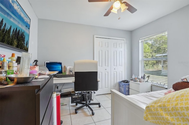 tiled bedroom with a closet and ceiling fan