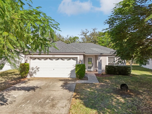 view of front facade with a garage and a front yard