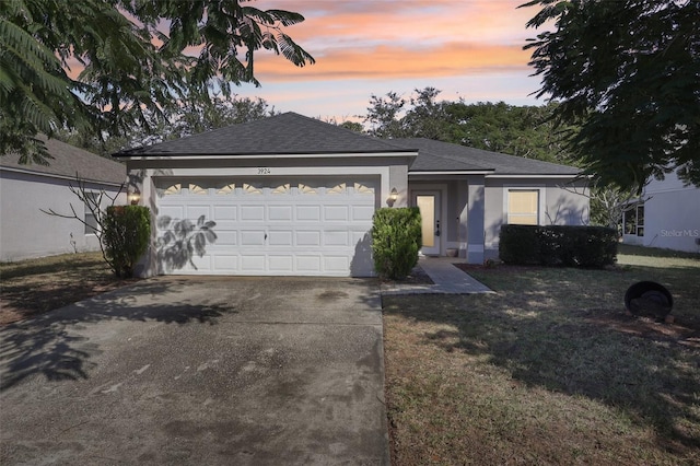 view of front of property with a lawn and a garage