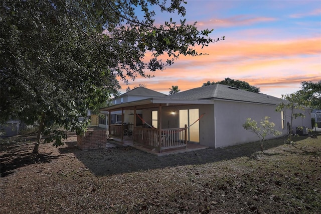 view of back house at dusk