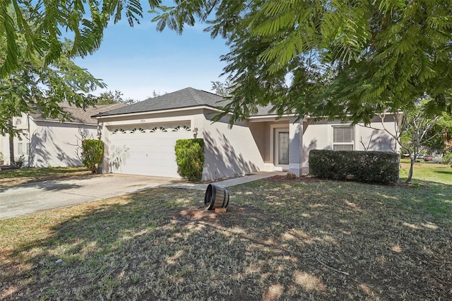 view of front of home with a front yard and a garage