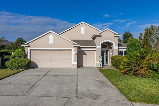 view of front facade with a front yard and a garage