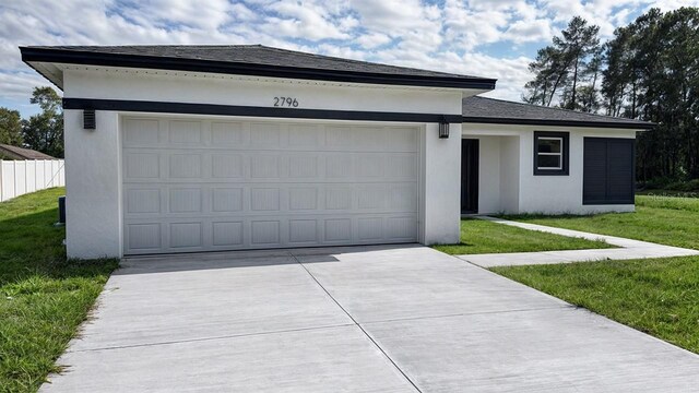 view of front facade featuring a front yard and a garage