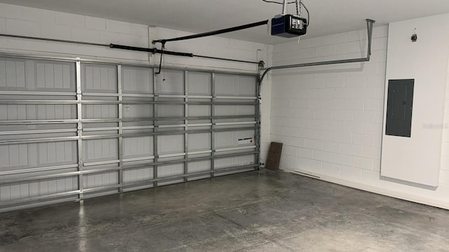 garage with a garage door opener and electric panel