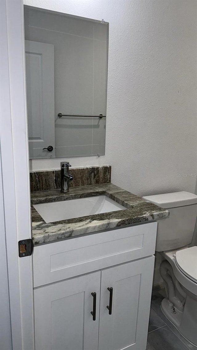 bathroom featuring vanity and toilet