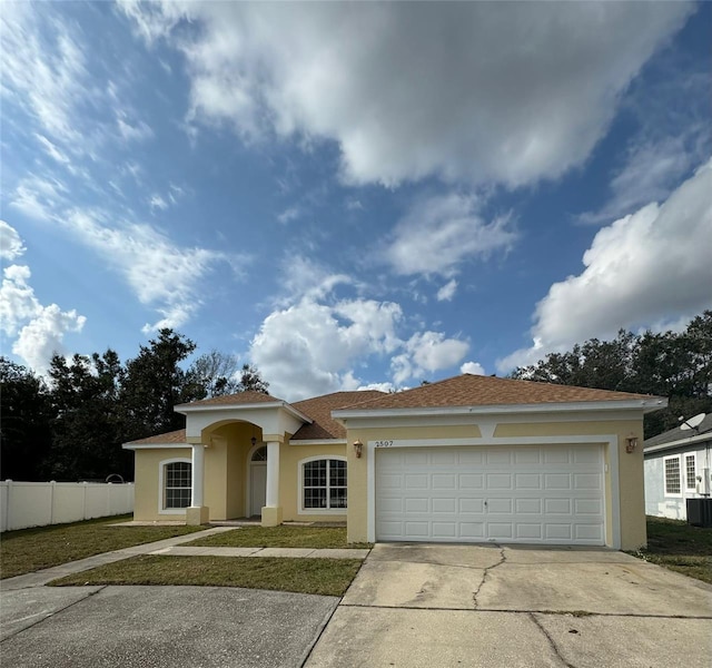 view of front of home featuring central AC and a garage