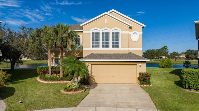 view of front of home featuring a water view, a front lawn, and a garage