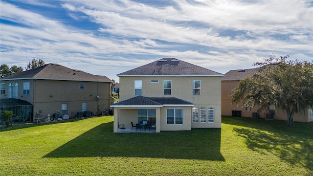 rear view of house featuring central AC, a patio area, and a lawn