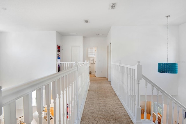 hall featuring light carpet