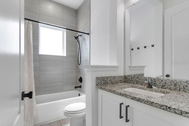 full bathroom with vanity, shower / bath combo, and toilet