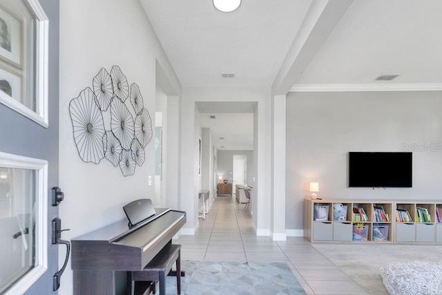 tiled entrance foyer featuring ornamental molding