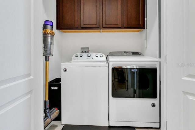 laundry room featuring cabinets and separate washer and dryer