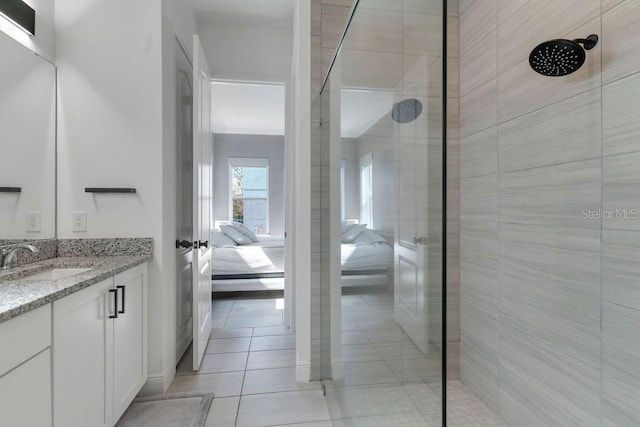 bathroom with vanity, crown molding, tiled shower, and tile patterned floors