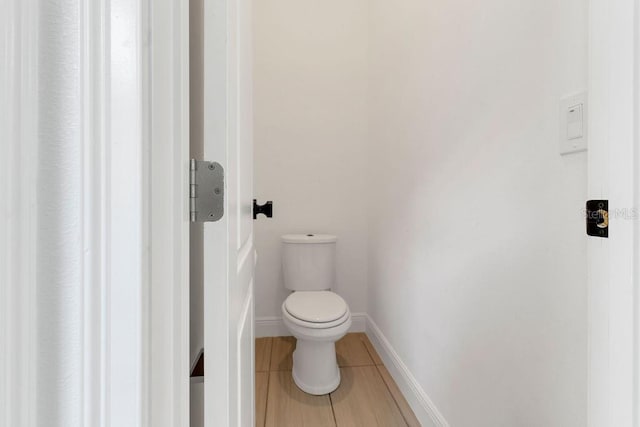 bathroom featuring toilet and tile patterned flooring