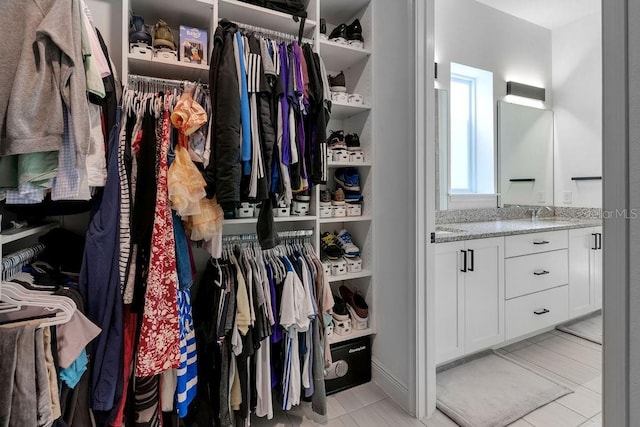 walk in closet with light tile patterned floors