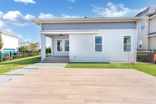 back of house with a patio area and a lawn