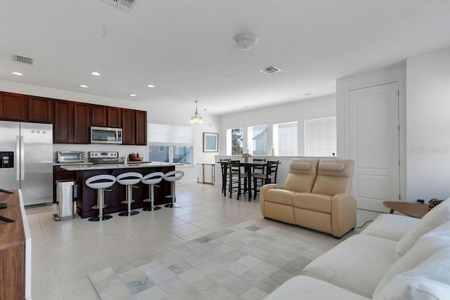 living room featuring an inviting chandelier and light tile patterned floors