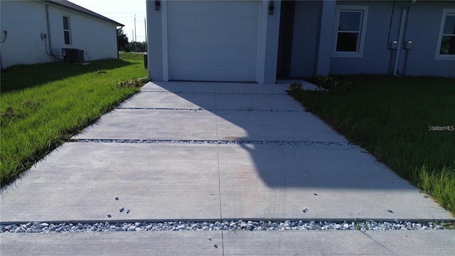 exterior space with a garage and central air condition unit