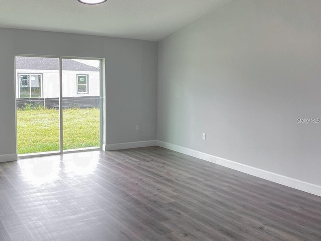 empty room with dark wood-type flooring