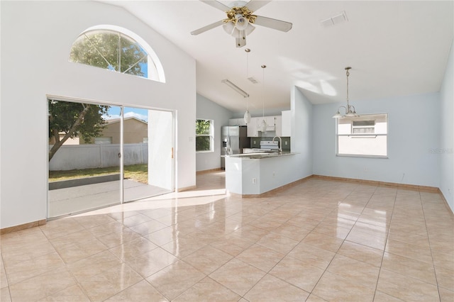 unfurnished living room featuring ceiling fan, high vaulted ceiling, plenty of natural light, and light tile patterned floors