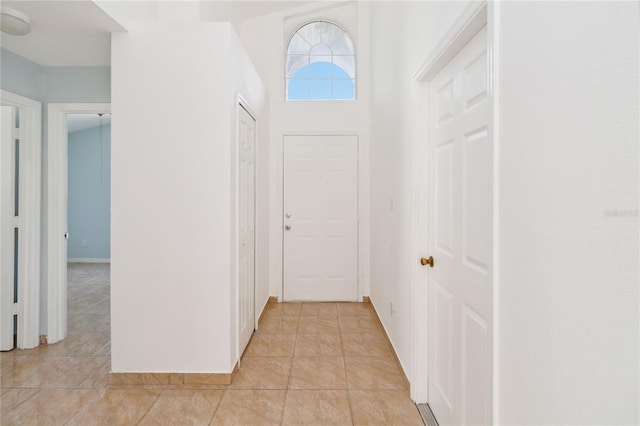 hall featuring light tile patterned floors