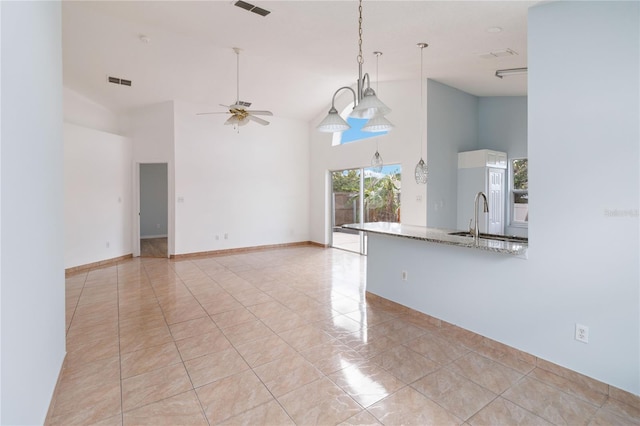 interior space with sink, ceiling fan, high vaulted ceiling, and light tile patterned floors