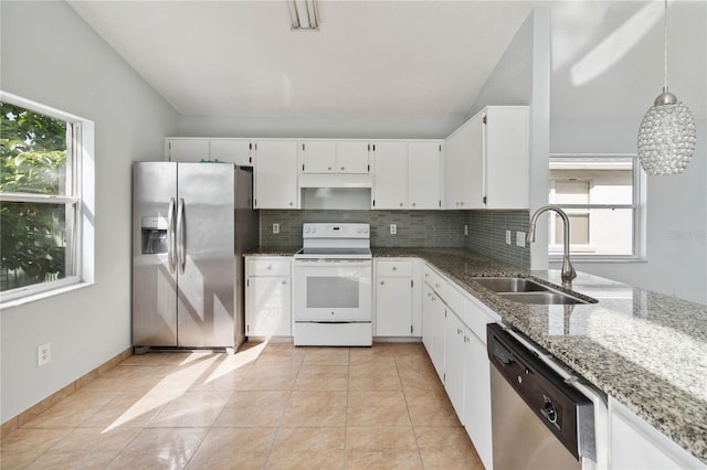 kitchen featuring stone countertops, sink, white cabinets, pendant lighting, and appliances with stainless steel finishes