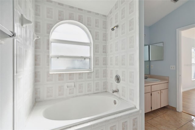 bathroom featuring vanity, tile patterned floors, and a bathing tub