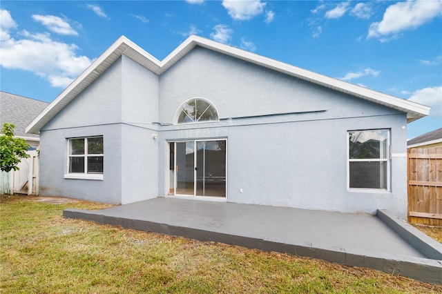 rear view of house featuring a yard and a patio area