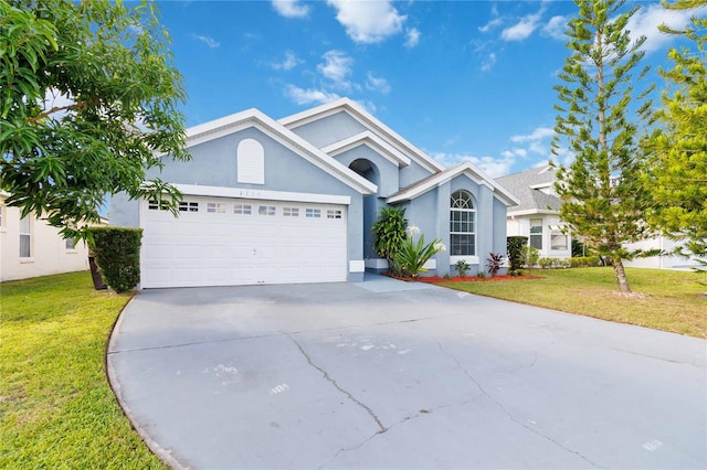 view of front of property featuring a front lawn and a garage