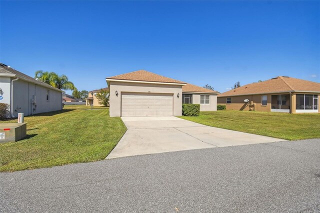 ranch-style house with concrete driveway, an attached garage, stucco siding, and a front yard