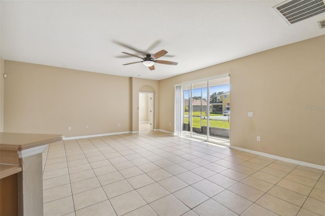 empty room with light tile patterned flooring and ceiling fan